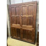 A Victorian panelled pitch pine four door cabinet, upper section marked in gilt, 'Newnham Girls