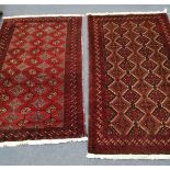 A near pair of Belouch burgundy ground rugs, larger 200 x 110cm