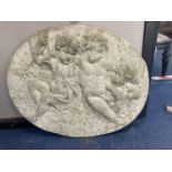 An oval reconstituted stone plaque, width 68cm, height 60cm