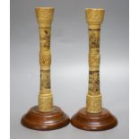 A pair of carved bone candlesticks, Meiji period, height 25cm