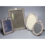 A George V oval silver photograph frame with reeded and beaded border, London 1910, 21.5cm and three