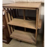 An Arts & Crafts light oak drop flap revolving bookcase, with a folding reading slope, width 68cm,