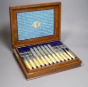 A Victorian oak cased set of twelve pairs of ivory handled silver dessert eaters, the knife blades