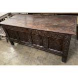 An 18th century carved panelled oak coffer, length 149cm, depth 62cm, height 67cm