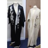 A Japanese black silk satin kimono embroidered with a white silk dragon, 133cm long and a cream silk