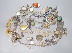 A mixed group of assorted white metal and costume jewellery including locket, brooches and filligree