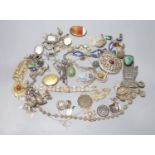 A mixed group of assorted white metal and costume jewellery including locket, brooches and filligree