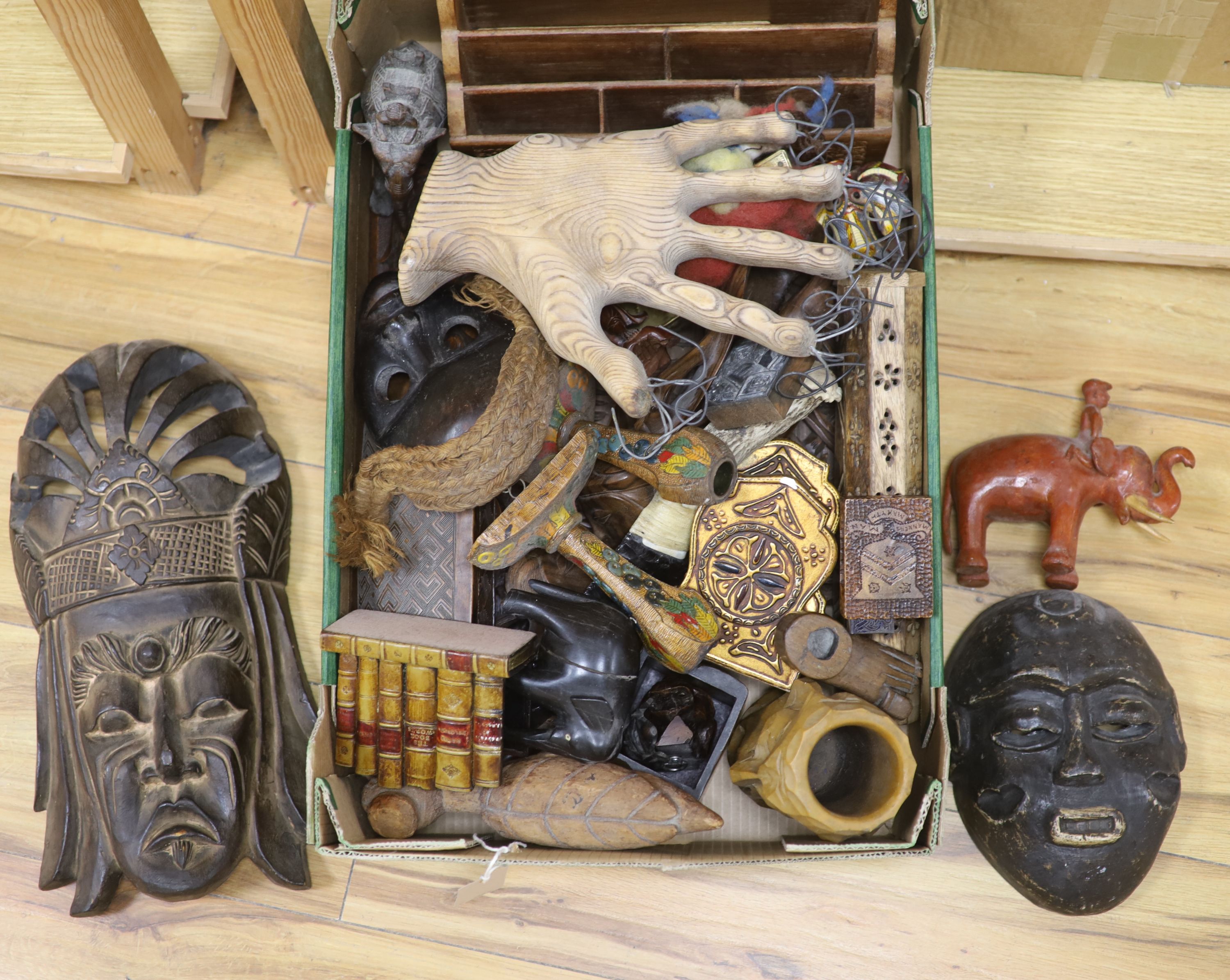 A quantity of mixed ethnographica carvings including tribal masks, bellows etc
