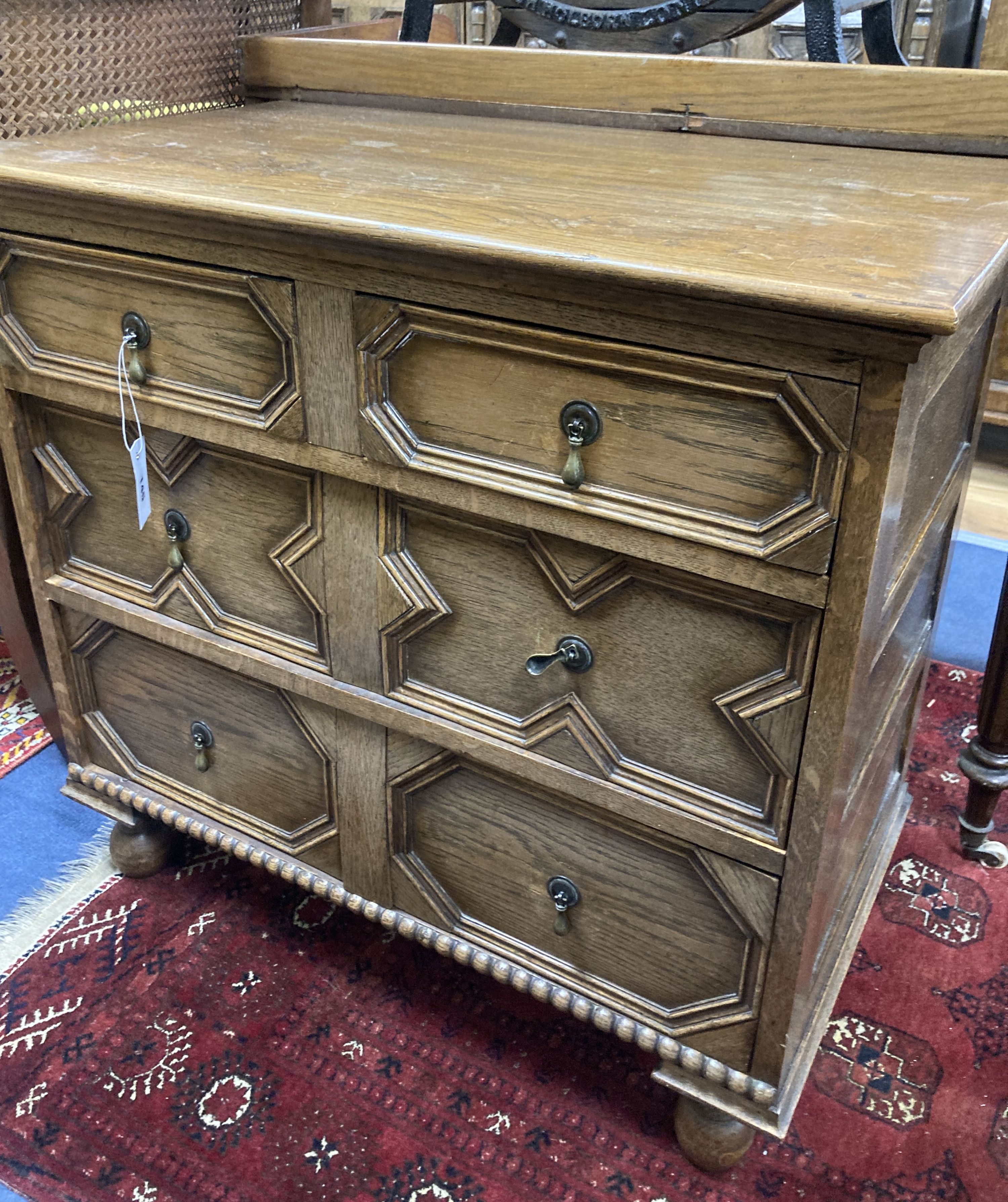 An early 20th century Jacobean style oak four drawer chest, width 81cm, depth 46cm, height 76cm