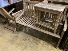 A weathered teak garden bench, length 129cm together with a teak steamer chair and nest of three