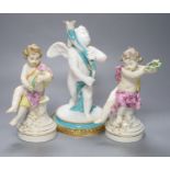 A pair of 19th century Berlin seated cherubs and a Continental porcelain figure of a cherub