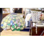 An Edwardian gilt metal and crystal drop bag chandelier and a Tiffany style lamp