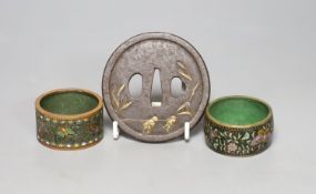 A 19th century Japanese iron and parcel gilt tsuba, unsigned, 8cm and two cloisonne enamel napkin