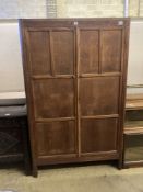 An Arts & Crafts style panelled oak two door wardrobe, width 105cm, depth 55cm, height 168cm