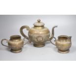 A Ceylonese white metal three piece tea set, teapot height 19.5cm, gross 34.5oz.