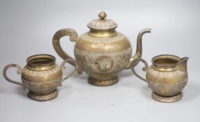 A Ceylonese white metal three piece tea set, teapot height 19.5cm, gross 34.5oz.