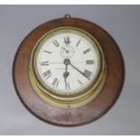 Kenneth James White Ltd., Glasgow and London. A brass cased bulkhead timepiece, mahogany mounted