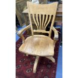 An Edwardian oak swivel desk chair, width 59cm, depth 49cm, height 98cm