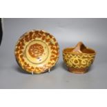 An early 19th century slipware basket, Donyatt Somerset and a similar slipware dish, diameter 18cm