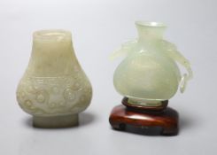 A Chinese celadon green jade vase, 7.4cm (lacking handles) and a Chinese bowenite jade vase, wood