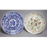 A Chinese famille rose dish and a blue and white dish, largest diameter 26cm