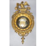 A small Regency style giltwood and gesso convex wall mirror, overall length 49cm