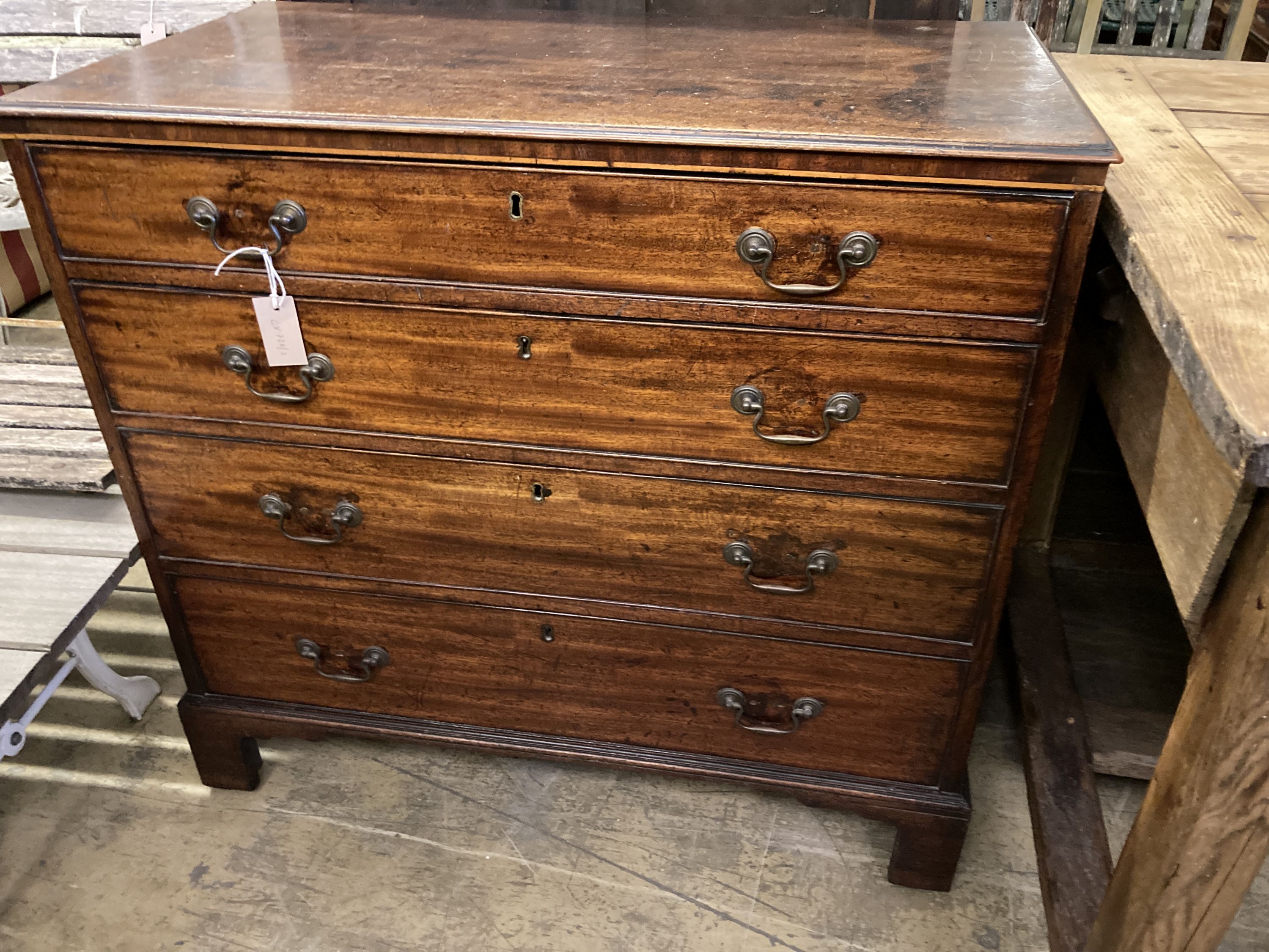 A late George III mahogany straight front chest, of four long graduated drawers, width 93cm, depth