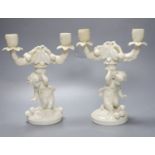 A pair of English bone china 'cherub' candelabra, possibly Moore Bros., height 26cm