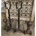 A pair of Victorian wrought iron fire dogs, together with one other pair of brass mounted fire dogs,