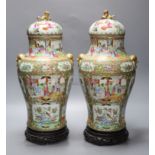 A pair of 19th century Cantonese vases and covers, with later stands, overall height 44cm (a.f.)
