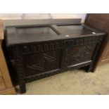 An 18th century carved oak coffer with twin panelled front, width 125cm, depth 55cm, height 75cm