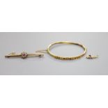 An Edwardian yellow metal, ruby and diamond set hinged bangle(a.f.) gross 5.2 grams, a 9ct, garnet