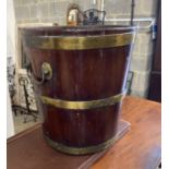 A George III circular brass bound mahogany peat bucket, fitted with two carrying handles, diameter