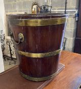 A George III circular brass bound mahogany peat bucket, fitted with two carrying handles, diameter