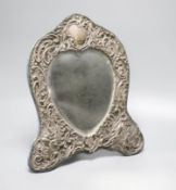 An Edwardian repousse silver mounted shaped easel mirror, Deakin & Francis, Birmingham, 1904,