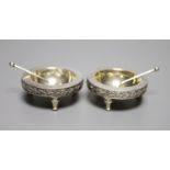 A pair of Victorian silver circular salts and matching spoons, on tripod stump feet, The Barnards,