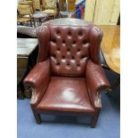 A pair of Chippendale-style buttoned leather wing armchairs, width 82cm, depth 72cm, height 94cm