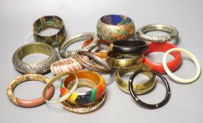 A collection of bangles, including five ethnic white metal examples, a faux tortoiseshell bangle