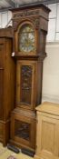 A 1914 carved oak eight day longcase clock, height 230cm