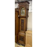 A 1914 carved oak eight day longcase clock, height 230cm