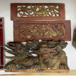 An early 20th century Chinese carved and polychrome painted wooden temple dragon, 21 x 38cm,