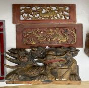 An early 20th century Chinese carved and polychrome painted wooden temple dragon, 21 x 38cm,