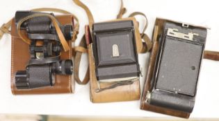 A Kodak Autograph camera, another camera and binoculars