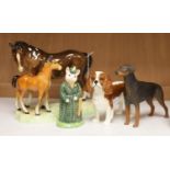 Four Beswick figures: The Lady Pig, King Charles Spaniel, a Doberman, and a horse and foal group,