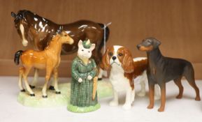 Four Beswick figures: The Lady Pig, King Charles Spaniel, a Doberman, and a horse and foal group,