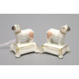 A pair of miniature Staffordshire porcelain pugs, on tassled cushion bases, c.1840, height 3.
