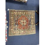 A Caucasian design red ground rug, 125 x 110cm