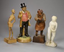 A German pottery figure and two alpine carved wood figures and a soapstone figure, tallest 21cm