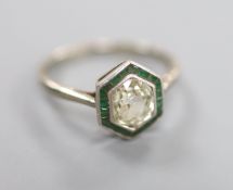 An 18ct white metal and plat, diamond and emerald hexagonal cluster ring, size K, gross 2.4 grams.