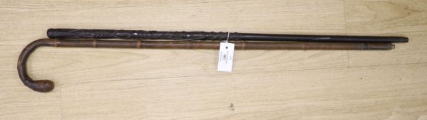 Victorian bamboo measuring stick and an Irish bog oak walking stick, longest 90cm